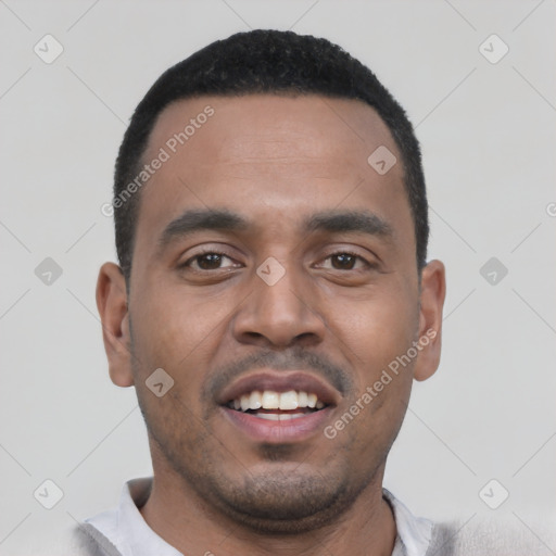 Joyful black young-adult male with short  black hair and brown eyes