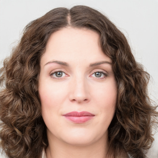 Joyful white young-adult female with long  brown hair and green eyes