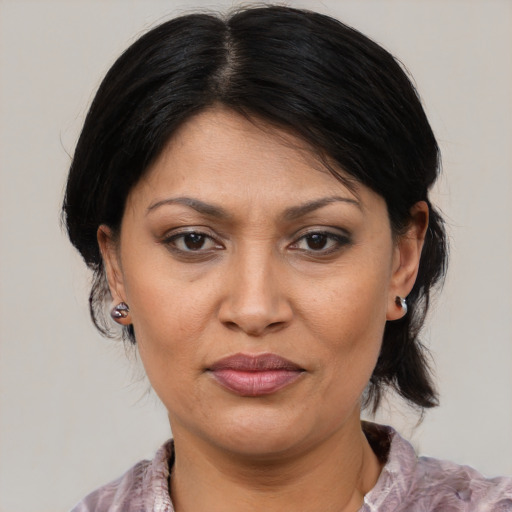 Joyful asian adult female with medium  brown hair and brown eyes