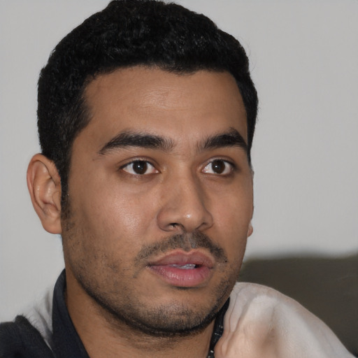 Neutral latino young-adult male with short  black hair and brown eyes