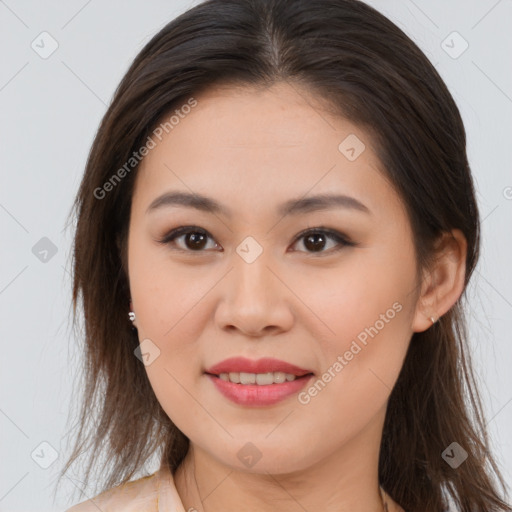 Joyful asian young-adult female with long  brown hair and brown eyes