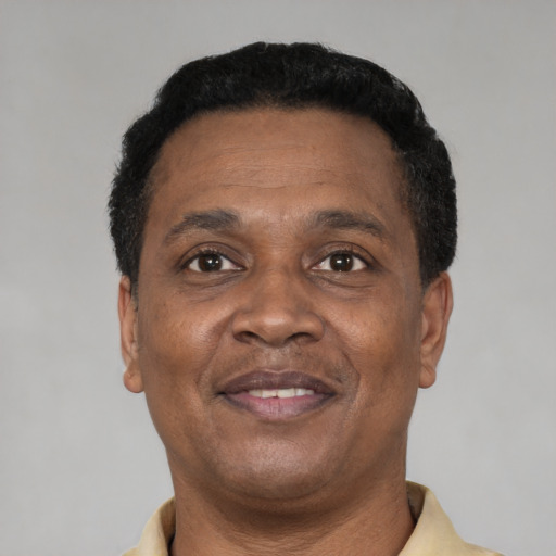 Joyful black adult male with short  black hair and brown eyes