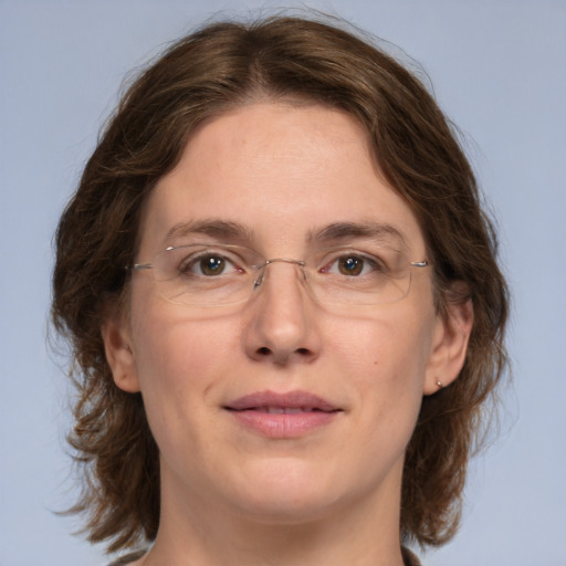 Joyful white adult female with medium  brown hair and green eyes