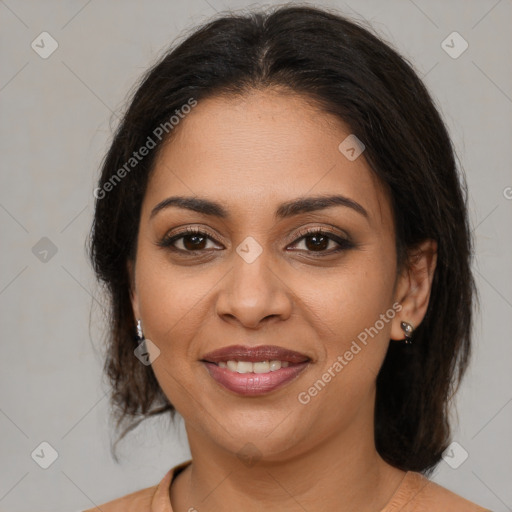 Joyful latino young-adult female with medium  brown hair and brown eyes