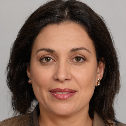 Joyful white adult female with medium  brown hair and brown eyes