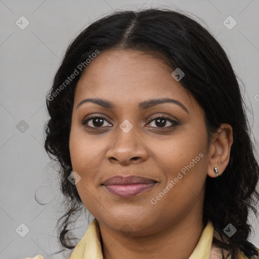 Joyful black young-adult female with long  brown hair and brown eyes