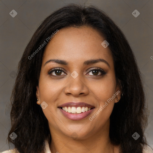 Joyful black young-adult female with long  brown hair and brown eyes