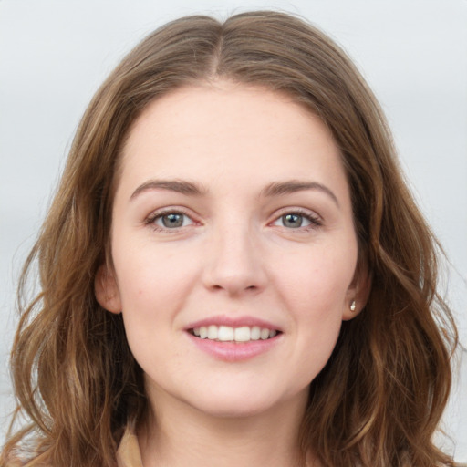 Joyful white young-adult female with long  brown hair and grey eyes