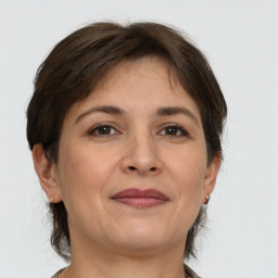 Joyful white adult female with short  brown hair and brown eyes