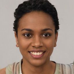 Joyful black young-adult female with short  black hair and brown eyes