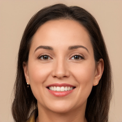 Joyful white young-adult female with long  brown hair and brown eyes