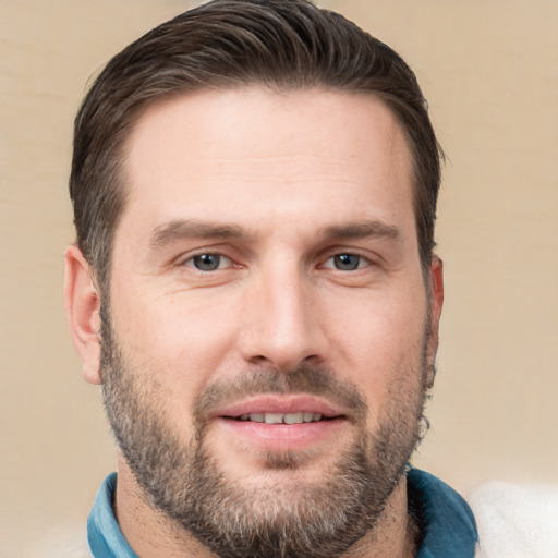 Joyful white adult male with short  brown hair and brown eyes