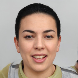 Joyful latino young-adult female with short  black hair and brown eyes