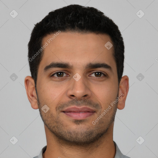 Joyful latino young-adult male with short  black hair and brown eyes