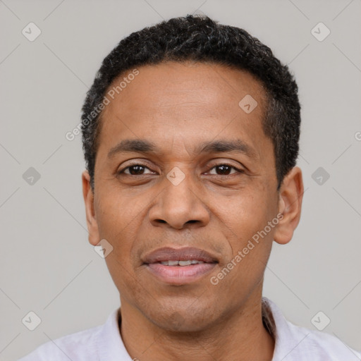 Joyful latino adult male with short  black hair and brown eyes