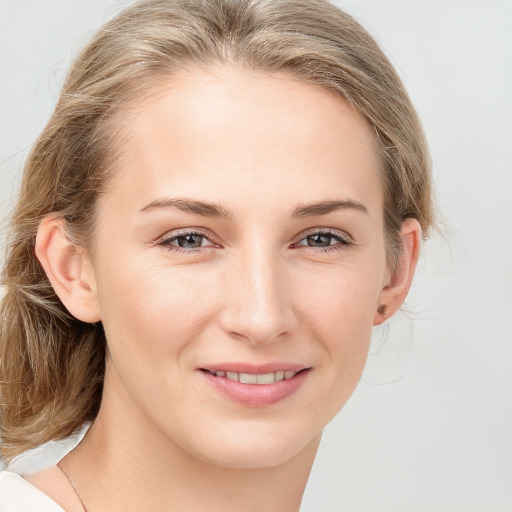 Joyful white young-adult female with medium  brown hair and blue eyes