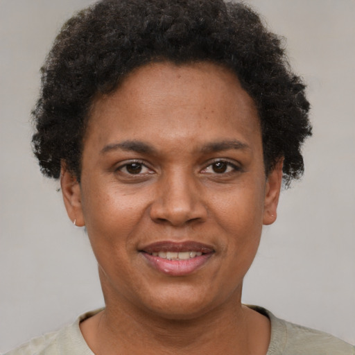 Joyful black adult female with short  brown hair and brown eyes