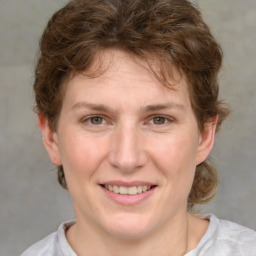 Joyful white young-adult female with medium  brown hair and blue eyes