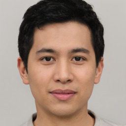 Joyful asian young-adult male with short  brown hair and brown eyes