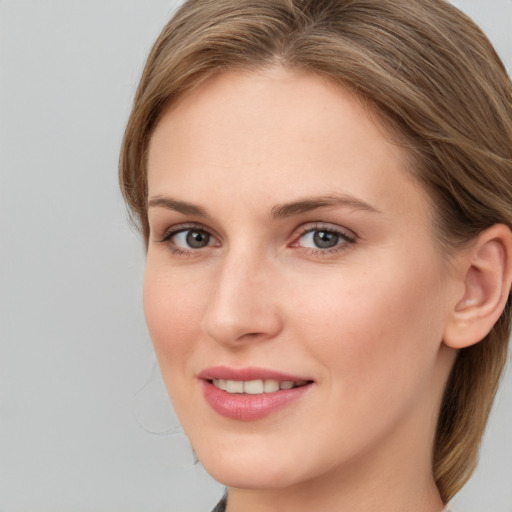 Joyful white young-adult female with long  brown hair and grey eyes