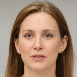 Joyful white adult female with medium  brown hair and grey eyes