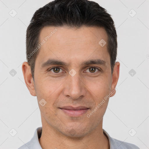 Joyful white adult male with short  brown hair and brown eyes