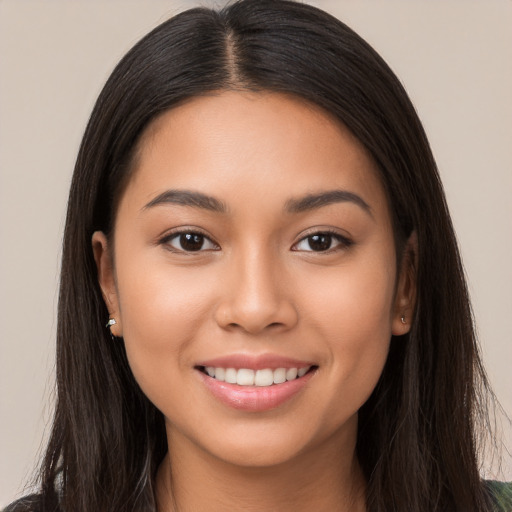 Joyful white young-adult female with long  brown hair and brown eyes