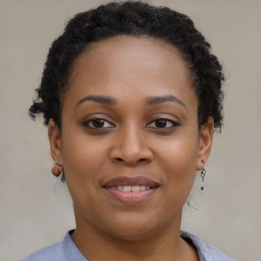 Joyful black young-adult female with short  brown hair and brown eyes