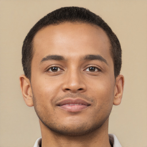 Joyful latino young-adult male with short  brown hair and brown eyes