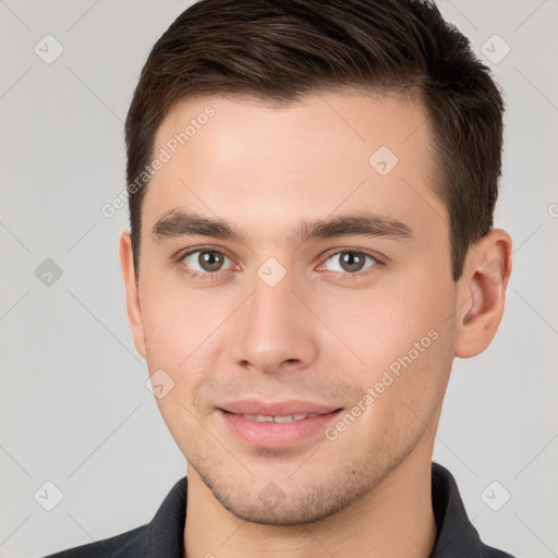 Joyful white young-adult male with short  brown hair and brown eyes