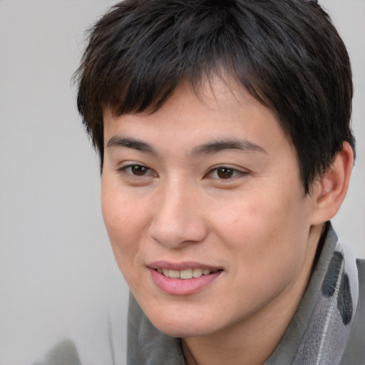 Joyful asian young-adult female with short  brown hair and brown eyes