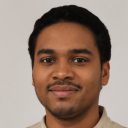 Joyful latino young-adult male with short  black hair and brown eyes