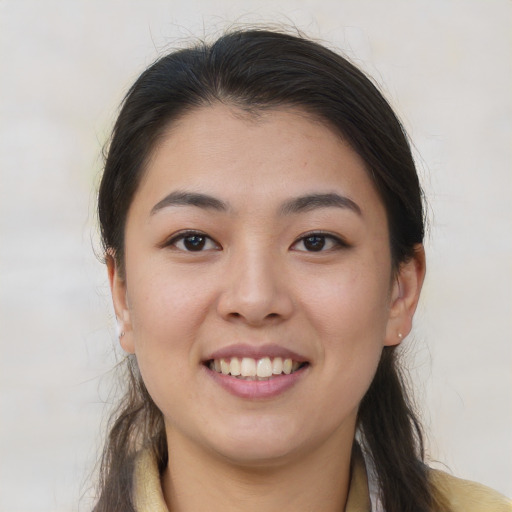 Joyful white young-adult female with long  brown hair and brown eyes