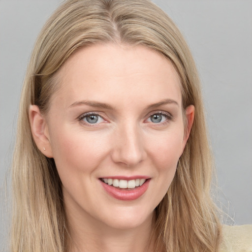 Joyful white young-adult female with long  brown hair and blue eyes