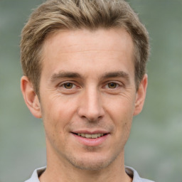 Joyful white adult male with short  brown hair and brown eyes