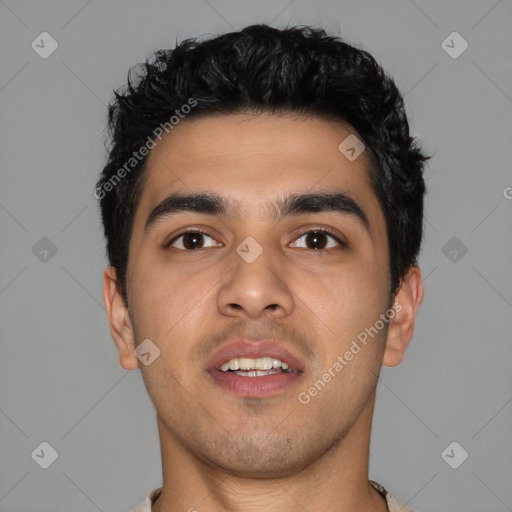 Joyful latino young-adult male with short  black hair and brown eyes