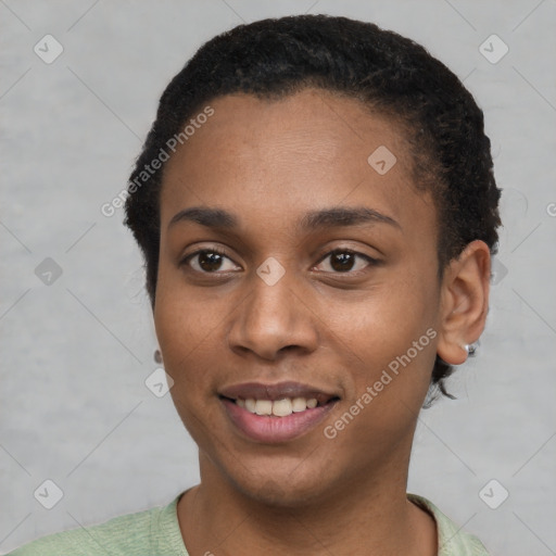 Joyful black young-adult female with short  brown hair and brown eyes