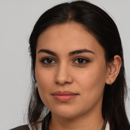 Joyful latino young-adult female with long  brown hair and brown eyes