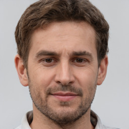 Joyful white adult male with short  brown hair and brown eyes