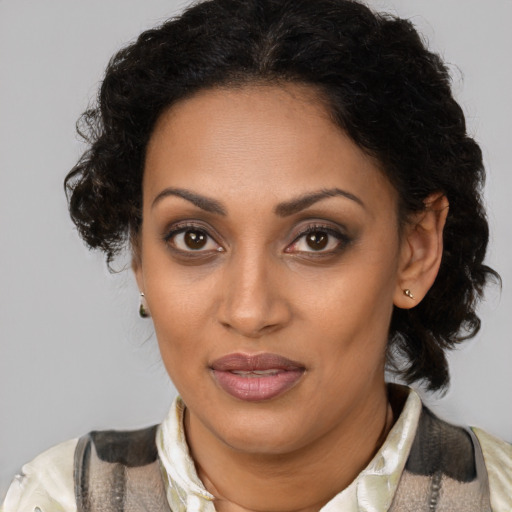 Joyful black young-adult female with medium  brown hair and brown eyes