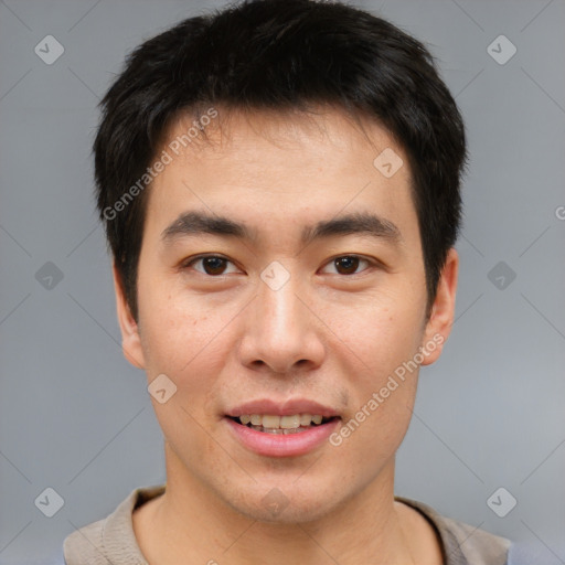 Joyful asian young-adult male with short  brown hair and brown eyes