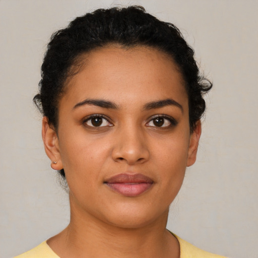 Joyful latino young-adult female with short  brown hair and brown eyes