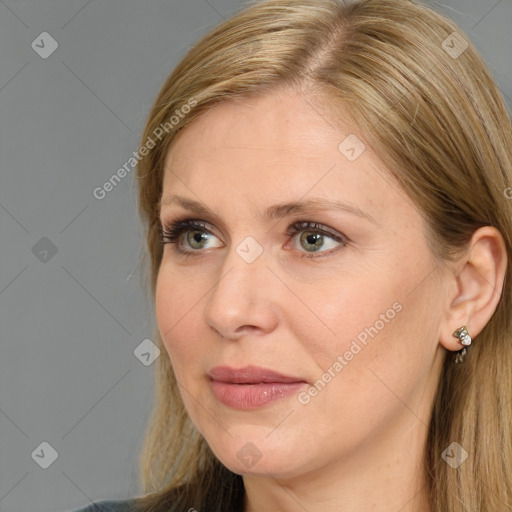 Joyful white adult female with long  brown hair and blue eyes