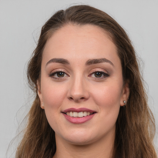 Joyful white young-adult female with long  brown hair and brown eyes