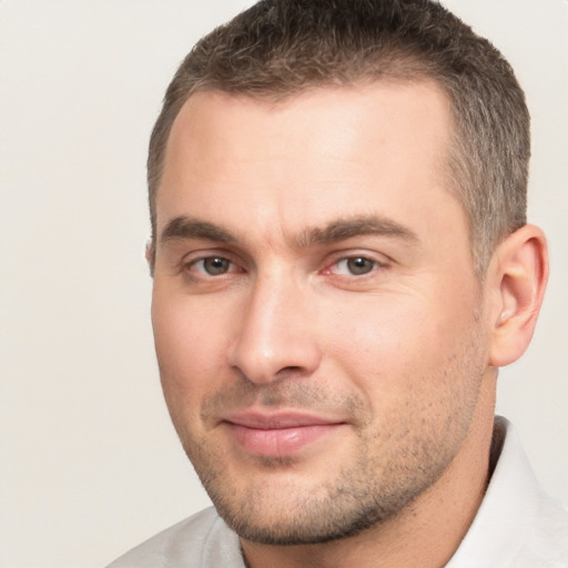 Joyful white young-adult male with short  brown hair and brown eyes