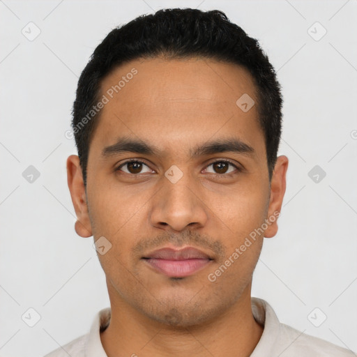 Joyful latino young-adult male with short  black hair and brown eyes