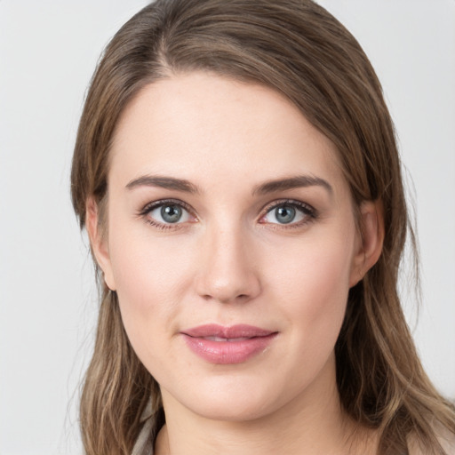 Joyful white young-adult female with long  brown hair and green eyes