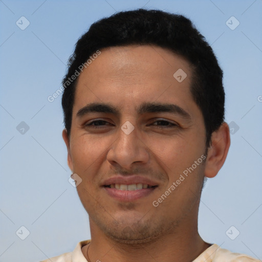 Joyful latino young-adult male with short  brown hair and brown eyes