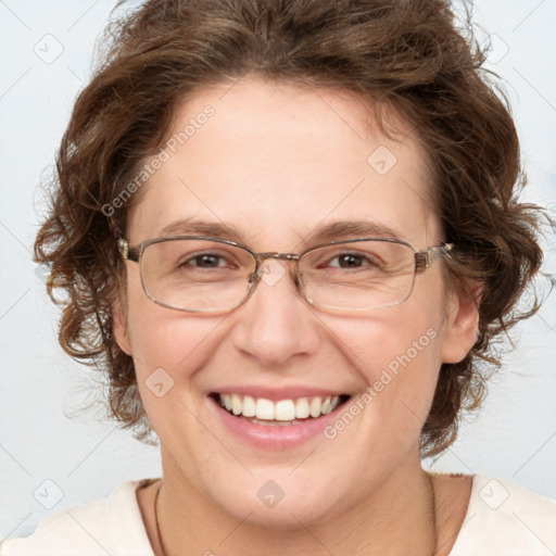 Joyful white adult female with medium  brown hair and green eyes