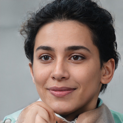 Joyful latino young-adult female with short  brown hair and brown eyes